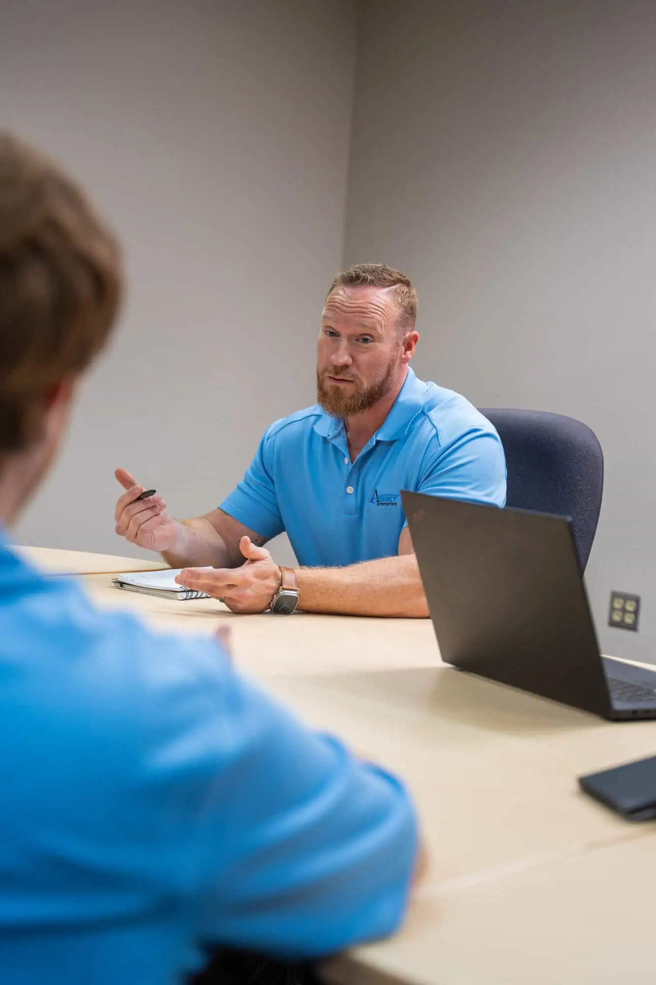 Team meeting discussing warranty management strategies at Asset Enterprises office.