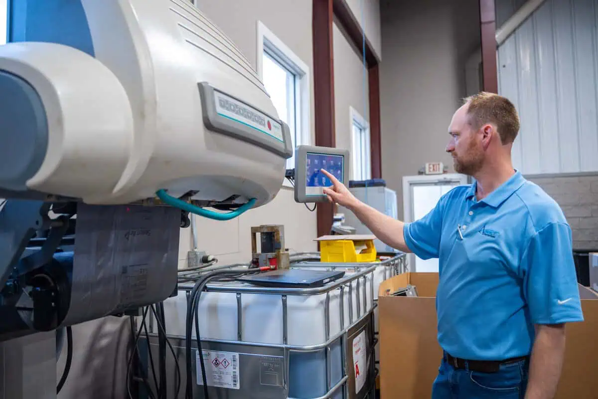 Technician using control panel for depot maintenance at Asset Enterprises facility, supporting partners.