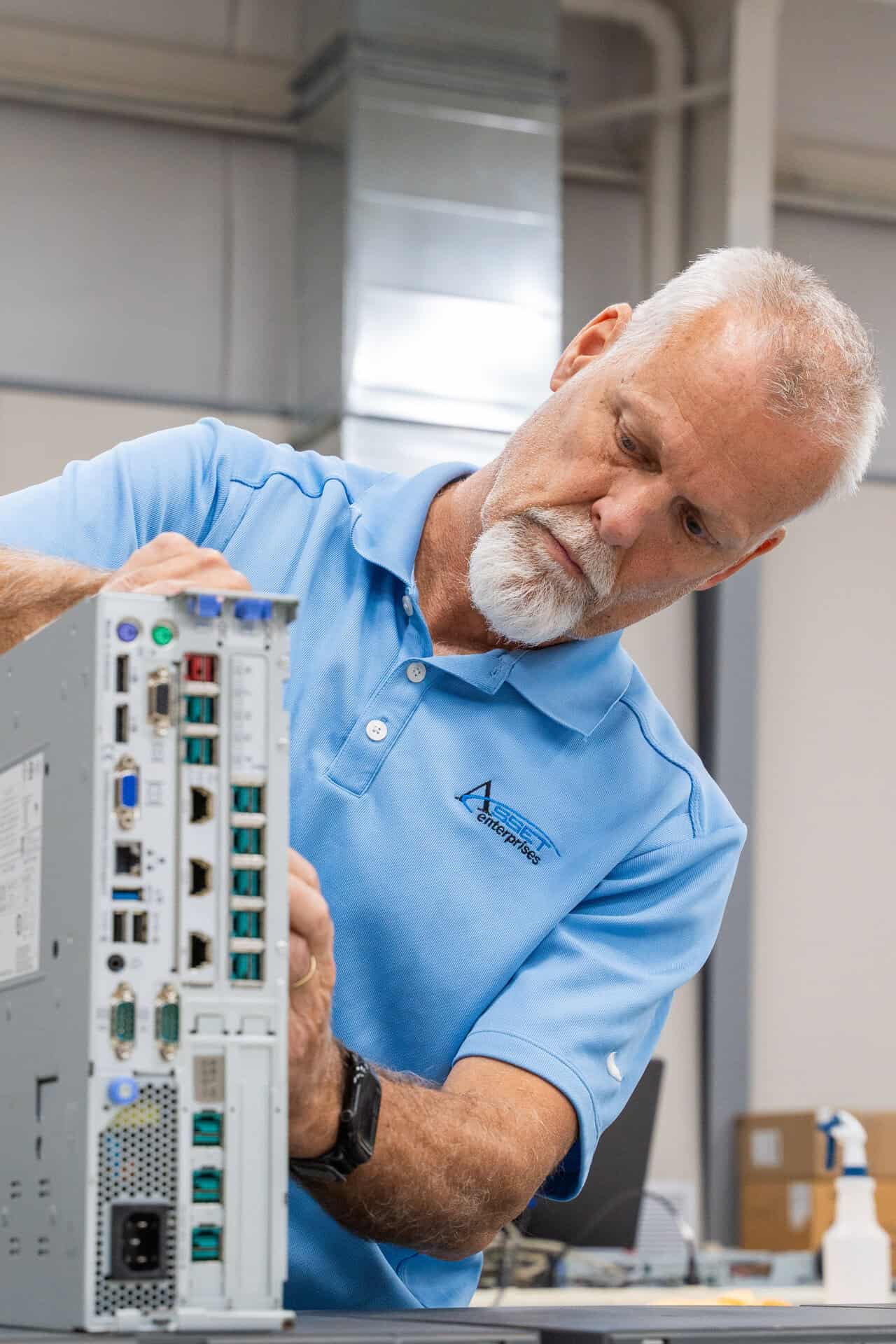 Technician inspecting used hardware server to ensure high-quality performance for maintenance operations.